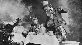 Go Ask Alice: The Mad Hatter’s tea party as seen in a 1910 theater production of ‘Alice In Wonderland.’