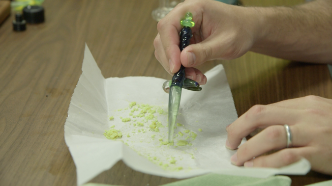 Distilled: Hartfield uses a dabber to scoop up marijuana concentrate.