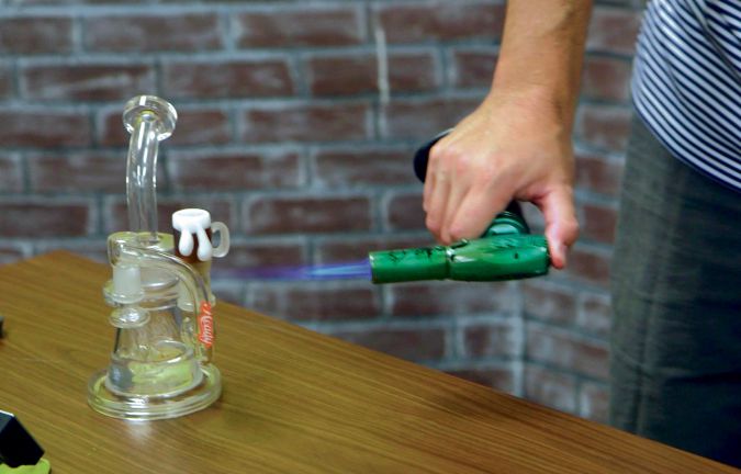 Up in Smoke: Hartfield applies a blow torch to vaporize a dab.